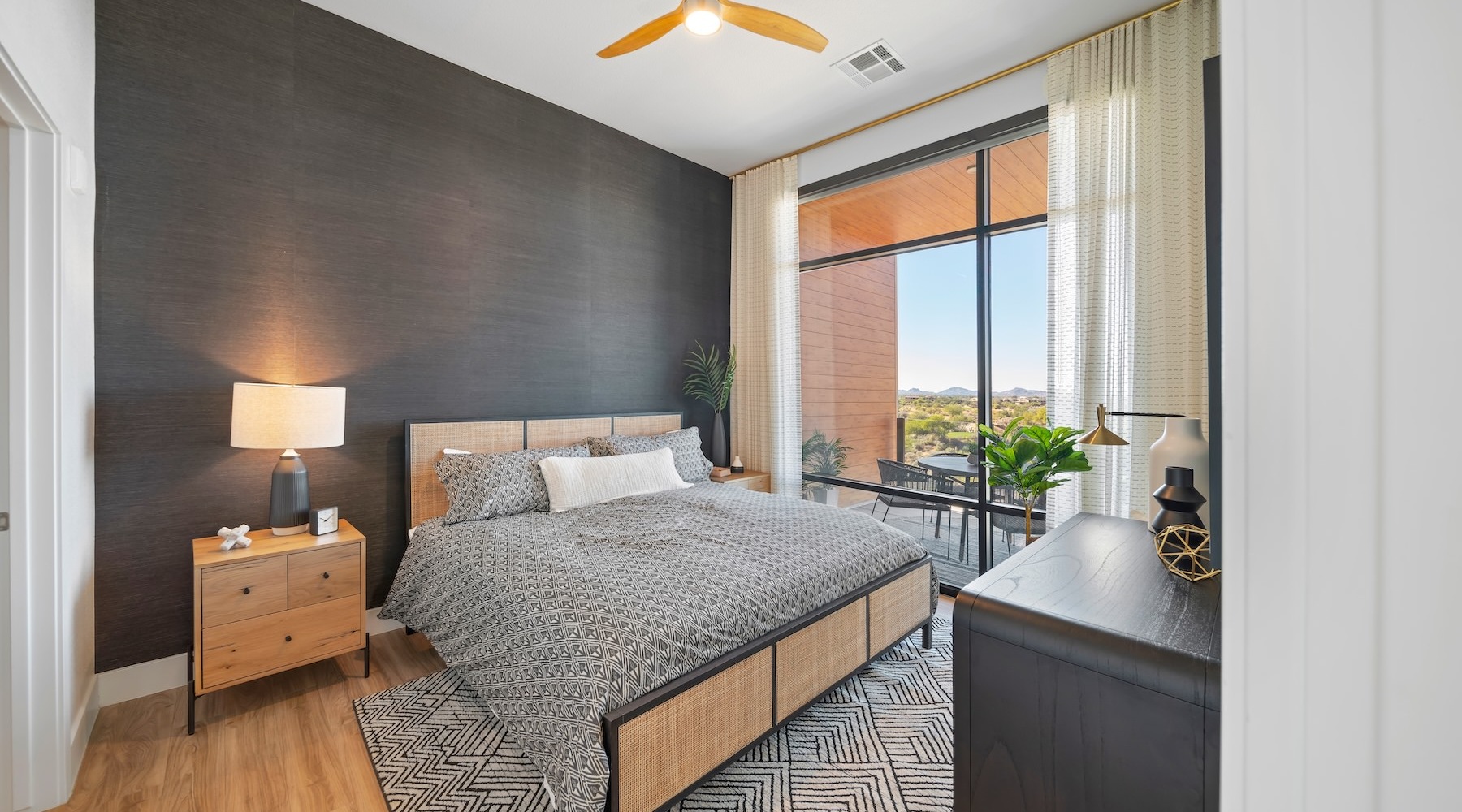 a bedroom with a bed and a large window