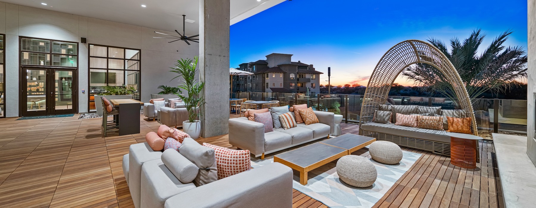 an outdoor lounge area with couches and a table