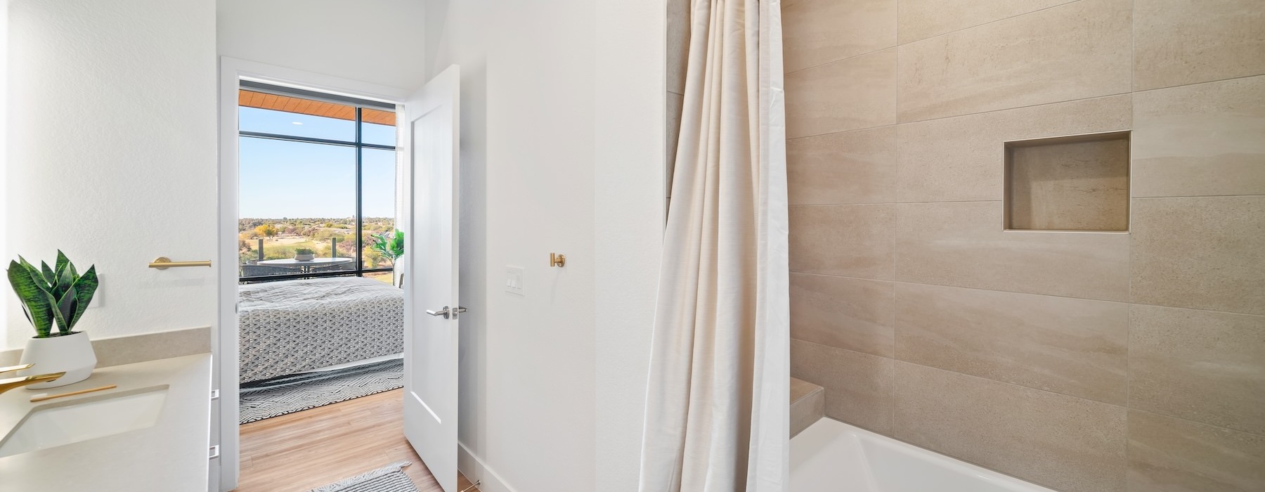 a bathroom with a bathtub and a shower curtain