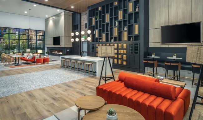 a clubhouse room with a tv and chairs